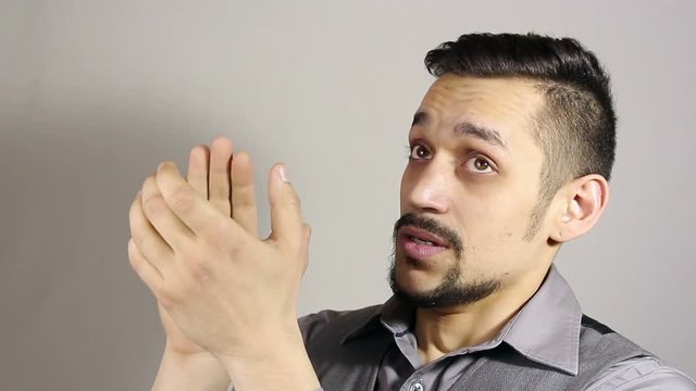 clapping sarcastically. young bearded man applauding.