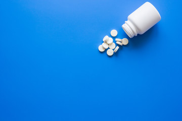 doctor's office table with pills on blue background top view mock up