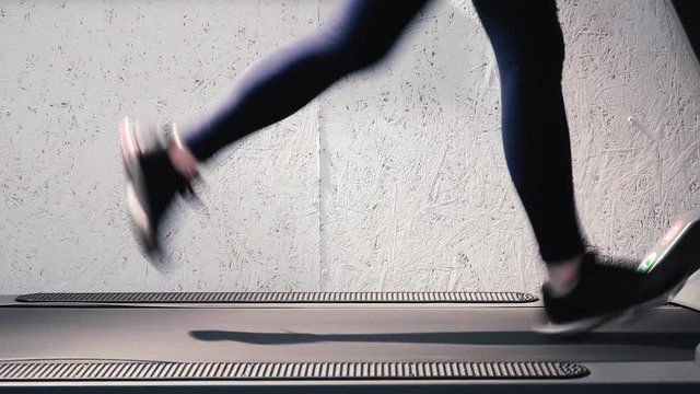 Exercising in the gym, treadmill cardio workout - detail close-up of beautiful legs. Sculpt, Shape and Define Your Legs Workout.