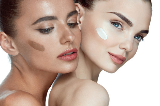 Face Cosmetics. Sexy Models With Foundation On Skin