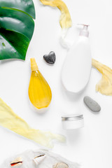 Woman cosmetic set with sun protection lotion white background top view