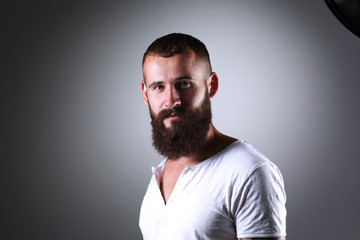 Portrait of handsome man standing, isolated on grey background