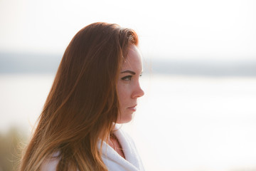 Portrait of a girl with long hair on the sun