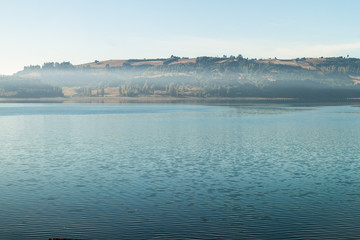 Fototapeta premium Morning mist on a sea in Castro, Chiloe island, Chile