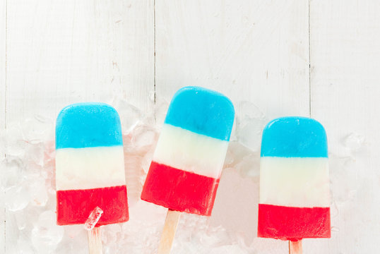 ICe Cream. Patriotic Red White Blue Popsicles For 4th Of July Holiday, On White Wooden Table. Copy Space Top View