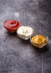 Set of different sauces: mustard, ketchup, mayonnaise.