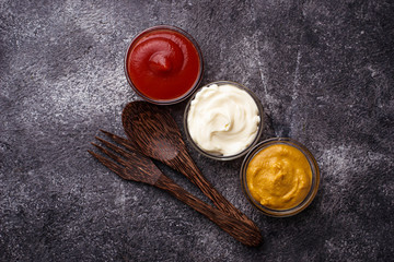 Set of different sauces: mustard, ketchup, mayonnaise.