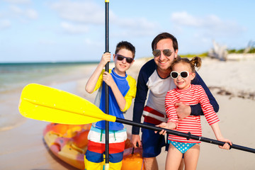 Family kayaking at tropical ocean