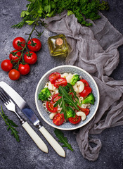 Salad with pasta, tomatoes, broccoli and arugula