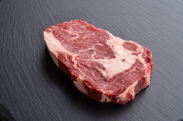 Fresh raw Prime Black Angus beef steak on stone background