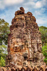 Stone faces of the famous Bayon temple in Angkor Thom complex, Siem Reap, Cambodia.