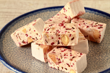 Pieces of white and dried red fruit nougat