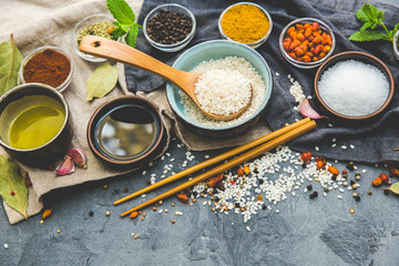 Rice and Food Ingredients over dark rustic background. Vegetarian concept. Asian or Indian food
