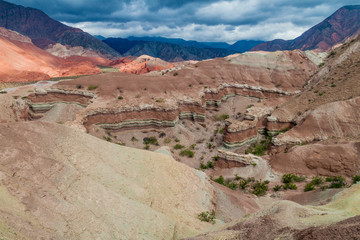 Fototapeta na wymiar Colorful layered rock formations in Quebrada de Cafayate valley, Argentina. National park Quebrada de las Conchas.