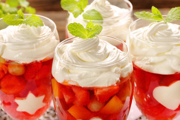 Delicious fruits jelly dessert in a glass with white gelatin shape decorations