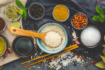 Rice and Food Ingredients over dark rustic background. Vegetarian concept. Asian or Indian food