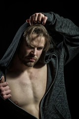 Hipster with bare chest. Young man in sweatshirt and hood
