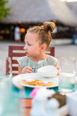 Little girl eating breakfast