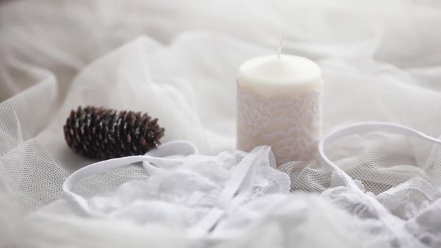 the white candle is lit on a white background