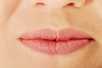 Fototapeta premium Part of face,young woman close up. Lips without makeup.