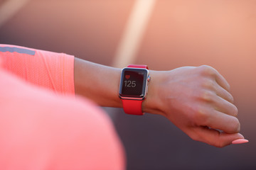 Sport woman looking at smart watch during training