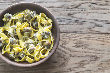 Portion of creamy mushroom pasta with pesto