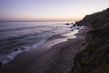 Malibu California pacific ocean dusk at El Matador State Beach.