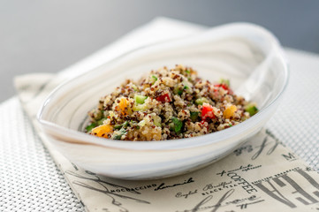 Quinoa salad bowl on white mat. Quinoa salads are very healthy and easy to do! Quinoa is a grain that originate from South America, it’s often called a super food due to its high nutritional content.
