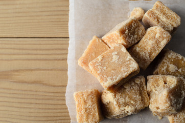Overhead of Fudge pieces on Parchment Paper and Wood