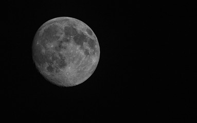 almost full moon in black sky