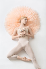 Blonde ballerina lies in studio