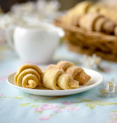 Many croissants on a table with spring flowers