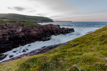 Waves crashing on the shores of Newfoundland in the setting sun