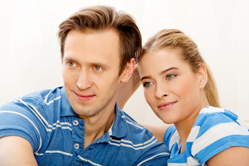 Smiling loving couple sitting on couch