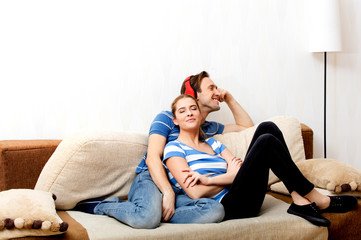 Couple relaxing on the sofa, man listening music
