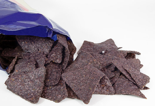 Blue Corn Chips Spilling From Bag.