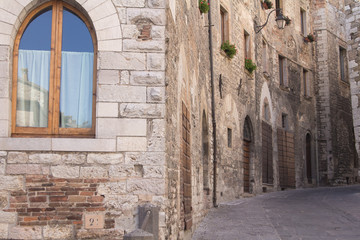 Fototapeta na wymiar Street of Gubbio with medieval buildings, Italy