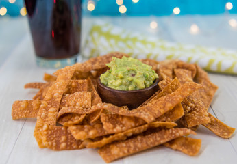 Guacamole and Chips With Bokeh Light Background