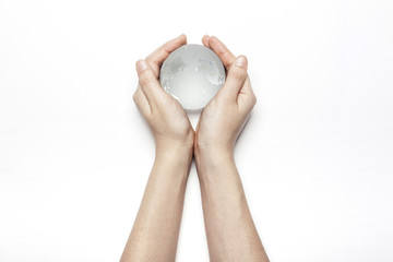 Fototapeta na wymiar woman hand hold a glass earth isolated white.