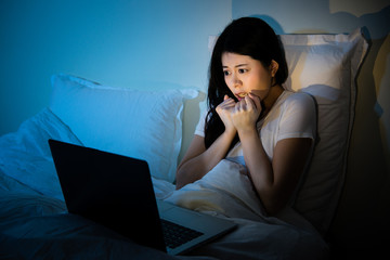 Pretty young woman watching horror movie