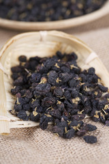 Traditional Chinese black herbs dried wolfberry close up. Black wolfberry, goji.