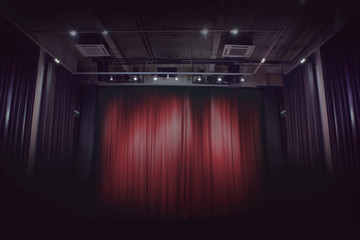 red stage curtain in a small theater