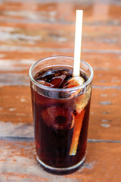 Cola in glass with ice cubes