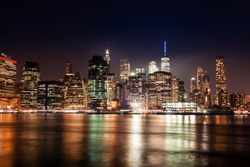 Fototapeta na wymiar New York City Manhattan downtown skyline on night skyscrapers illuminated over Hudson River panorama