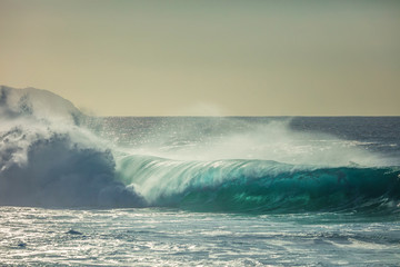 Blue ocean shorebreak wave for surfing sport activity. Template with nobody on background. Tropical summer scenery