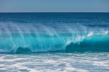 Blue ocean shorebreak wave for surfing sport activity. Template with nobody on background. Tropical summer scenery