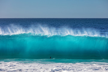Blue ocean shorebreak wave for surfing sport activity. Template with nobody on background. Tropical summer scenery