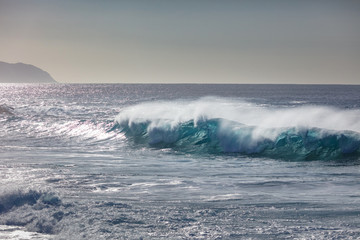 Blue ocean shorebreak wave for surfing sport activity. Template with nobody on background. Tropical summer scenery