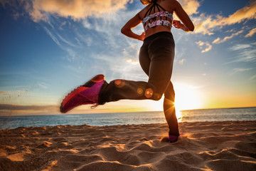 Healthy lifestyle sports woman running on sandy beach sunset seaside