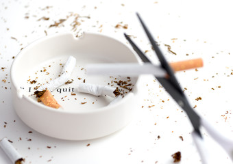 white ashtray with destroyed cigarette that emphasize words 